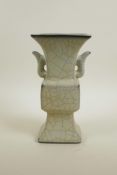 A Chinese crackle glazed pottery Gu shaped vase with two handles, raised character marks to base, 9"