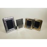 A pair of silver plated photograph frames with pressed corn sheath decoration, and two others,