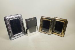 A pair of silver plated photograph frames with pressed corn sheath decoration, and two others,