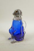 A silver plated and blue glass claret jug in the form of a monkey, 8" high, crack to handle