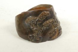 A Chinese carved hoof decorated with figures in a landscape, 4½" x 5"