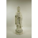 A Chinese blanc de chine porcelain figure of Buddha standing on a lotus flower, impressed seal marks