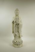 A Chinese blanc de chine porcelain figure of Buddha standing on a lotus flower, impressed seal marks