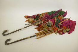 Two African parasols with cast brass handles, canopies very A/F, 30" long