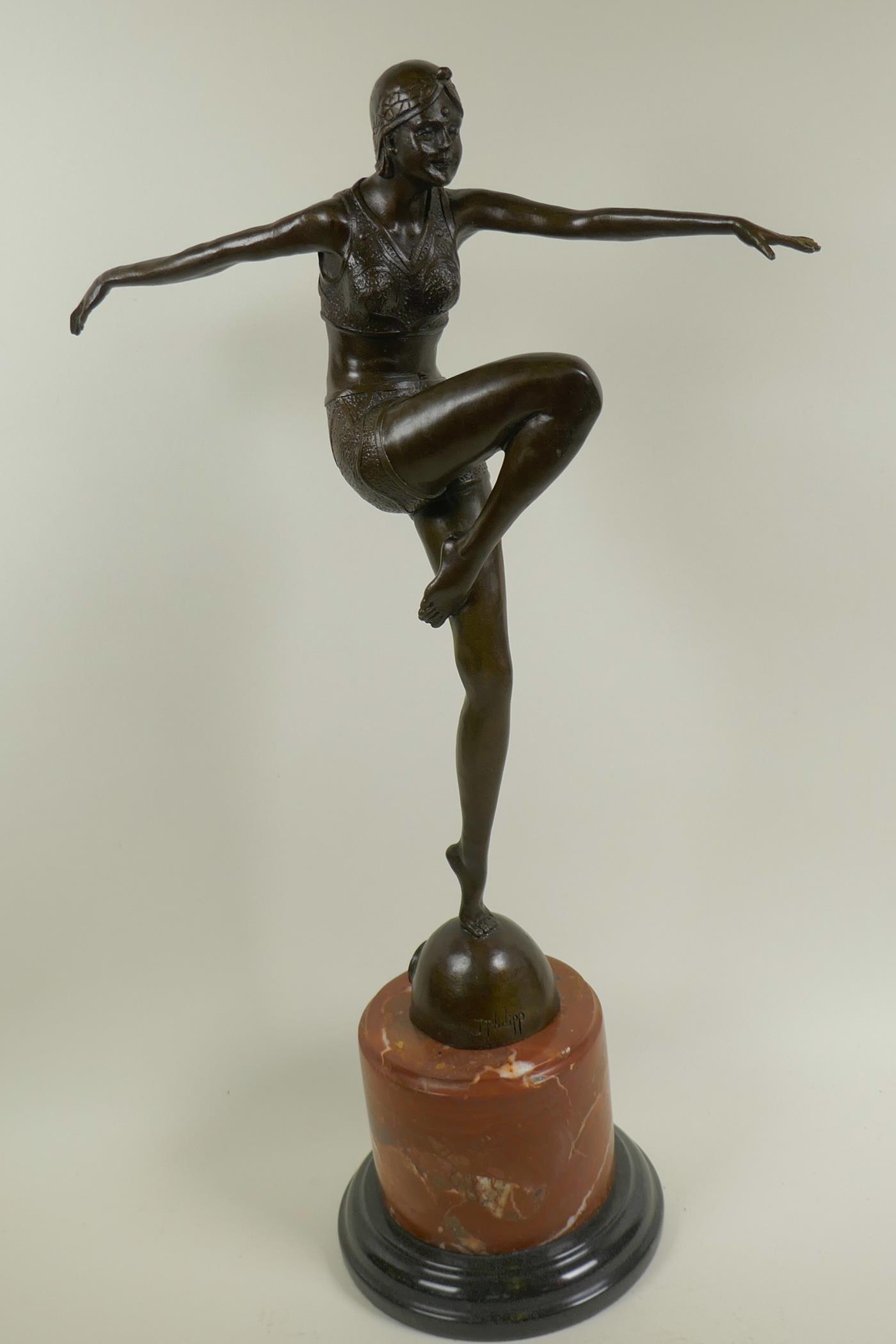An Art Deco style bronze figure of a dancing girl, on a marble plinth, 22" high
