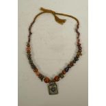 An Indian graduated hardstone, agate and coral bead necklace with a white metal and amethyst set