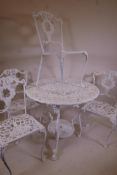 A painted cast iron garden table and four chairs, 36" diameter, 28½" high