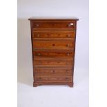 A Continental style inlaid walnut semainier with seven moulded front drawers, raised on bracket