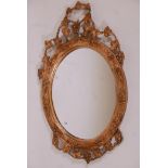 A giltwood and composition oval wall mirror with grape and vine decoration, 22" x 38"