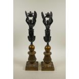 A pair of bronzed spelter lamps in the form of winged female figures, 18½" high