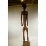 A large African carved hardwood devilish figure with horns, 43" high