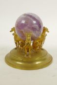 A fluorspar crystal ball on a triform ormolu stand in the form of dogs, 4" high