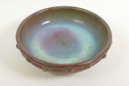 A Chinese Song style porcelain shallow bowl with studded decoration and brown/green glaze on three