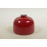 A Chinese red glazed porcelain ink pot, six character mark to base, 4" diameter