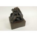 A Chinese bronze seal cast with an entwined dragon, 5" square, 6½" high