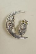 A sterling silver brooch in the form of an owl on a crescent moon, 1"