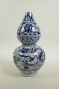 A Chinese Ming style blue and white porcelain vase with dragon and lotus flower decoration, 10" high