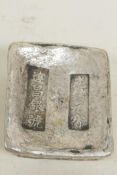 A Chinese white metal ingot decorated with calligraphy, 1½" x 2"