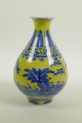 A Chinese yellow glazed porcelain pear shaped vase with blue and white landscape decoration, seal