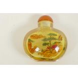 A Chinese interior painted glass snuff bottle decorated with landscape scenes, 2" high
