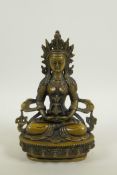 A Sino-Tibetan bronze of a female deity seated on a lotus throne, 8½" high