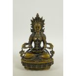 A Sino-Tibetan bronze of a female deity seated on a lotus throne, 8½" high