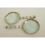 A pair of brass and mother of pearl framed and handled magnifying glasses, 4" diameter
