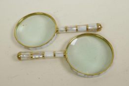 A pair of brass and mother of pearl framed and handled magnifying glasses, 4" diameter