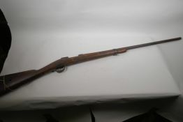 A vintage bolt action rifle stock and barrel, 51" long
