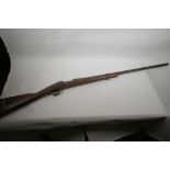 A vintage bolt action rifle stock and barrel, 51" long