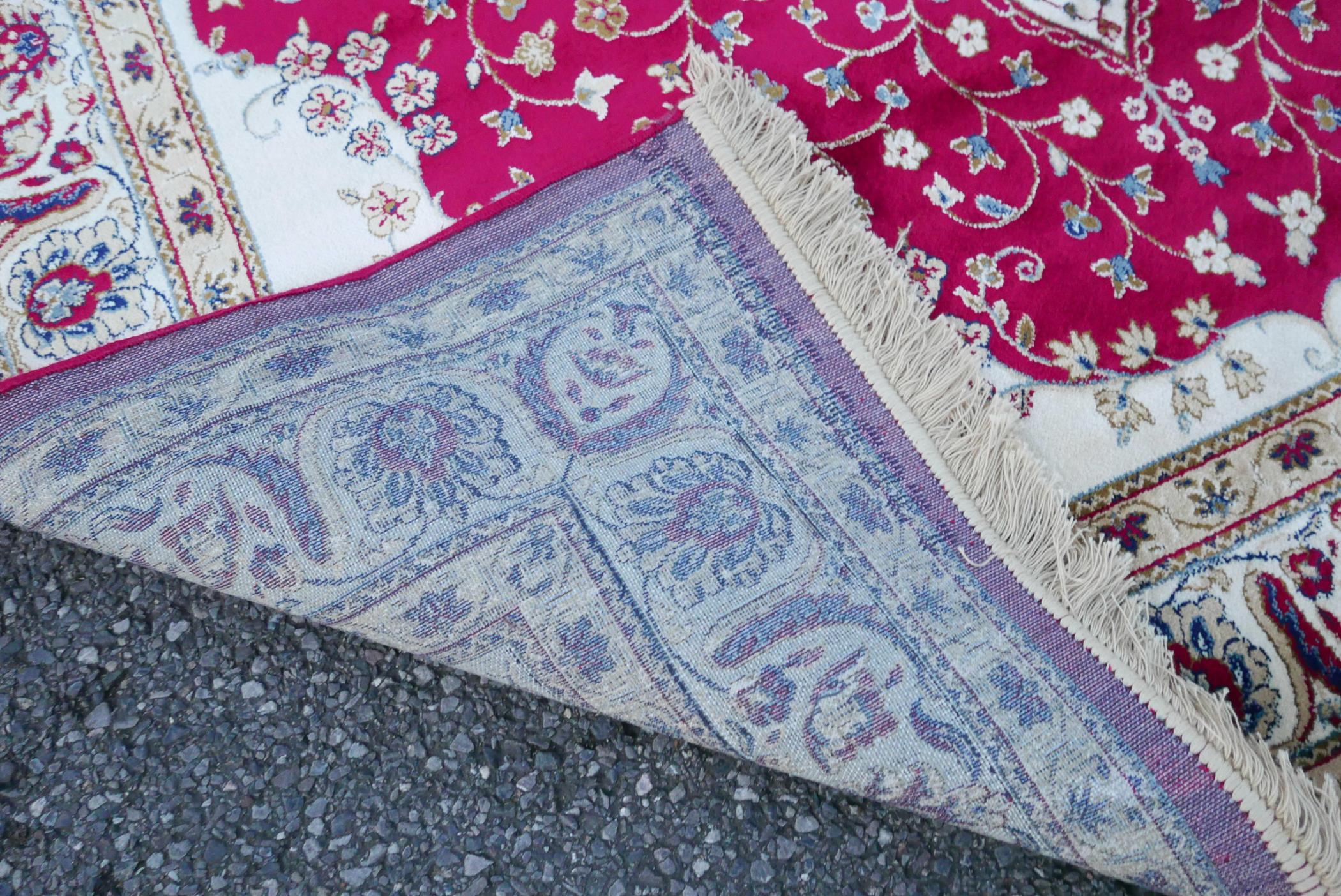 A Kashmiri red ground rug with an unique floral medallion design, 61½" x 91" - Image 5 of 5