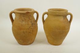 A pair of continental terracotta two handled jars, 8" high