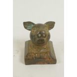 A Chinese brass seal, the handle formed as a pig's head, 1" square