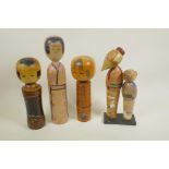 Four Japanese painted wood Kokeshi dolls, largest 12" high