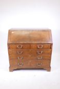 An early C19th walnut bureau with crossbanded inlay decoration, fitted interior, and two short