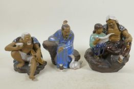 A Chinese Shiwan style pottery of a man and young girl reading a paper, 7" high, and two other