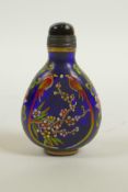 A blue Peking glass snuff bottle with enamelled decoration of birds and flowers, 4 character mark to