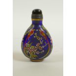 A blue Peking glass snuff bottle with enamelled decoration of birds and flowers, 4 character mark to