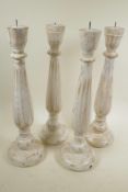 Four painted and distressed turned wood pricket candlesticks, 18" high