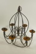 A wrought iron six branch candelabra, 14" drop, 14" diameter