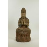 A Chinese carved, painted and distressed wood figure of Quan Yin, 14½" high