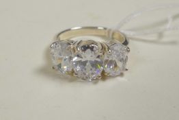 A 925 silver and cubic zirconium three stone ring, approximate size 'N/O'