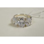A 925 silver and cubic zirconium three stone ring, approximate size 'N/O'