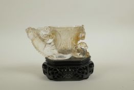 A Chinese moulded glass libation cup with pierced dragon, kylin and phoenix decoration, on an