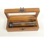 A brass three draw telescope in a hardwood box with glass lid (5½" long closed)