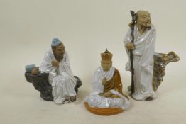 Three Chinese, Shiwan style, mud men figures in white robes, largest 8" high