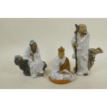 Three Chinese, Shiwan style, mud men figures in white robes, largest 8" high
