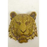 A cast brass tiger's mask wall plaque, 7" long