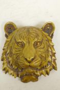 A cast brass tiger's mask wall plaque, 7" long