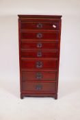 A Chinese hardwood chest with seven drawers, moulded panel sides and back, raised on shaped